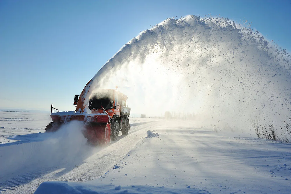 Snow removal truck clearing a road during a Manitoba blizzard