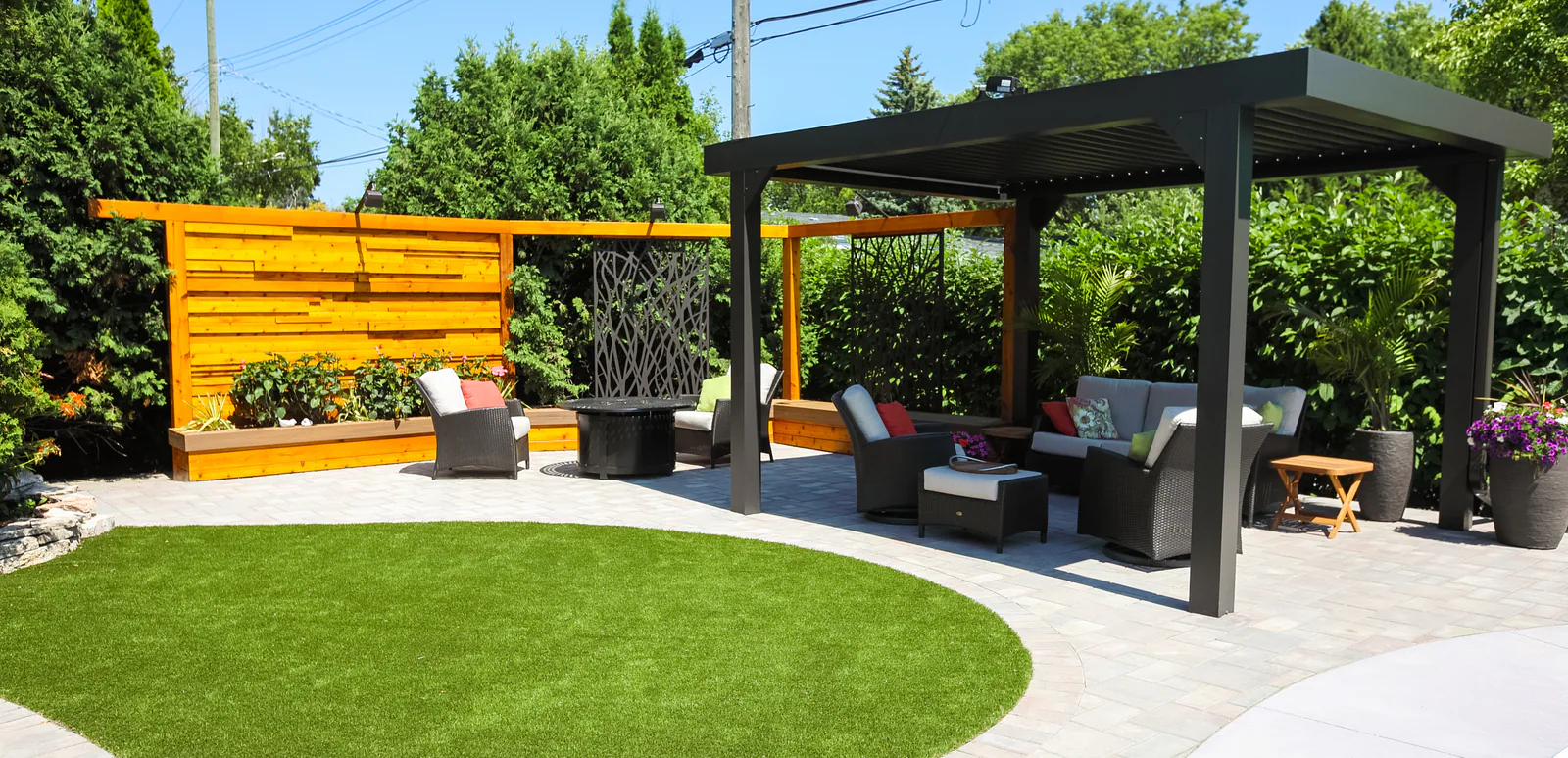 Backyard pergola beside a curved synthetic turf lawn
