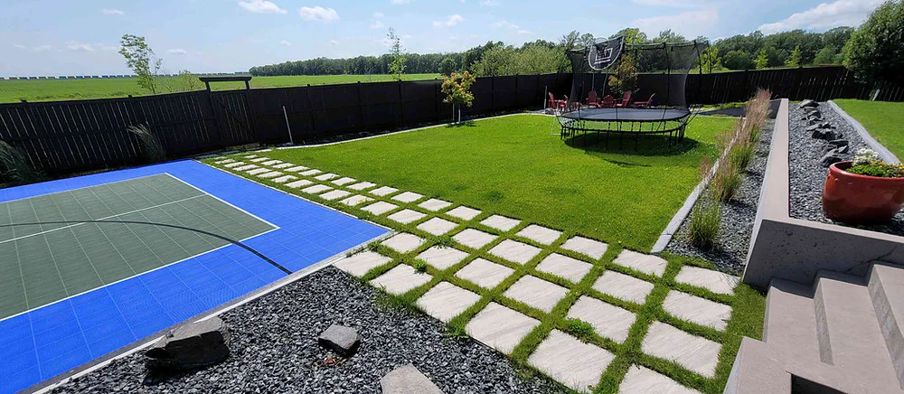 Modern Canadian backyard with pavers, turf and decorative gravel