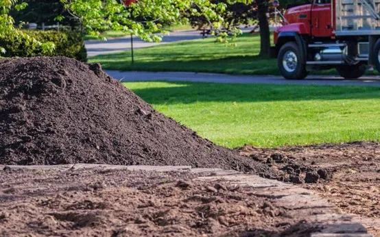 Bulk topsoil delivered beside a Winnipeg lawn