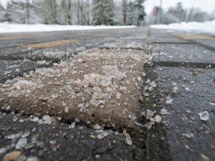 Sand and salt spread across an icy Winnipeg roadway