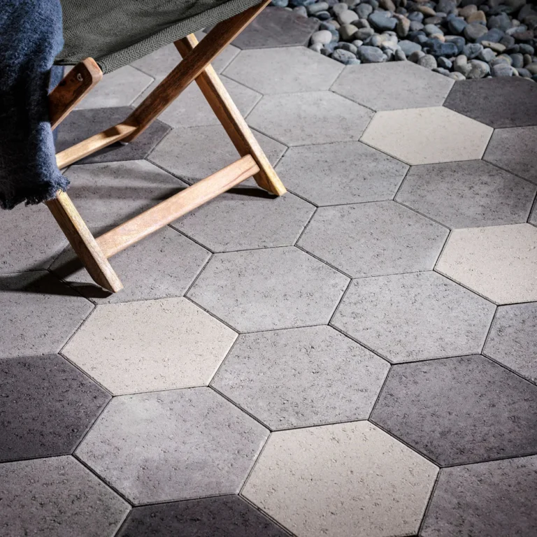 Interlocking concrete pavers installed beside a swimming pool